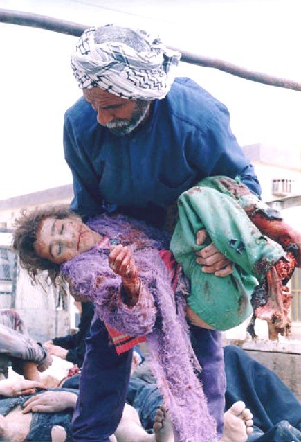 Iraqi man carrying a bloodied Iraqi child