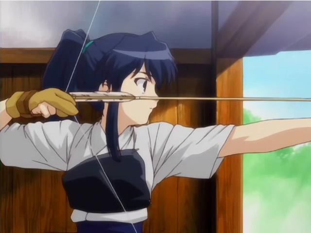 A girl in traditional Japanese archery clothes is stretching a bow, her long black hair in a pony tail